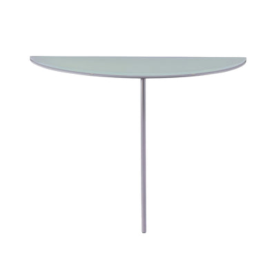 Cappellini One Legged Table by Jasper Morrison. A sleek glass tabletop with a curved edge sits atop a silver metal pedestal.