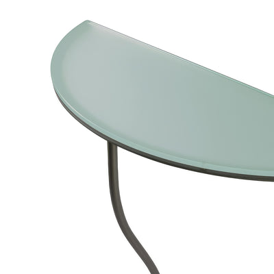 Cappellini One Legged Table by Jasper Morrison. A curved frosted glass surface sits atop a sleek dark metal support leg.