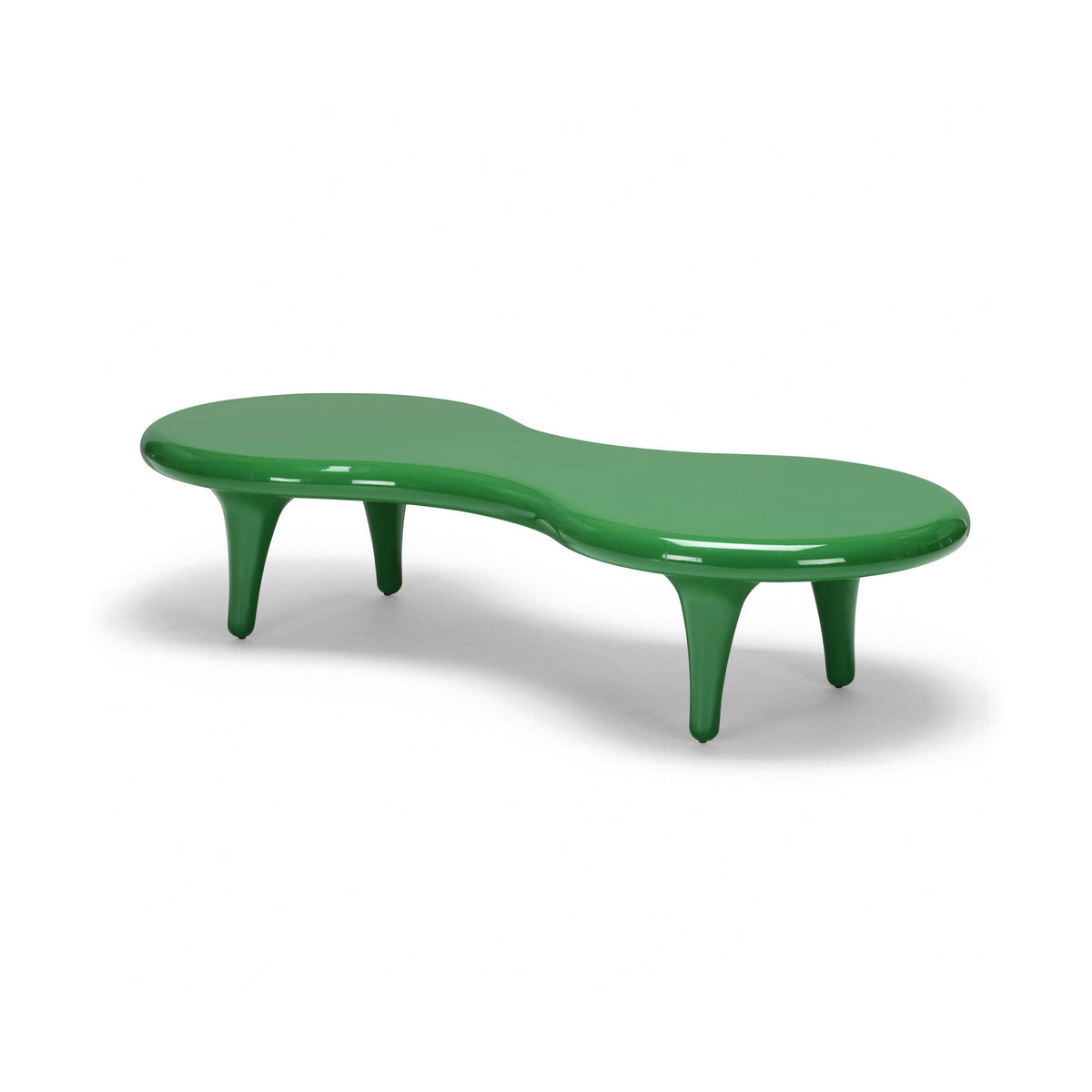 Cappellini Orgone Table by Marc Newson. A glossy green curved bench with tapered legs sits on white.
