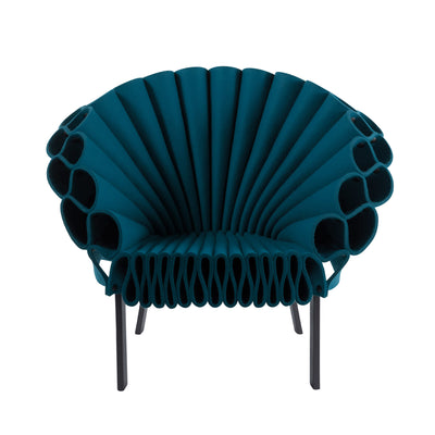 Cappellini Peacock by Dror. A teal blue sculptural chair with radiating pleated panels and metal legs.