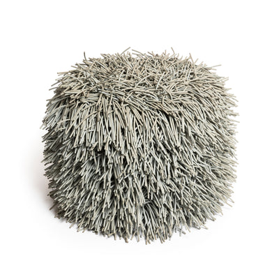 COVO Porcupine Pouf by Rosanna Contadini. A spherical ball of thin, tan-colored straw or dried grass strands.