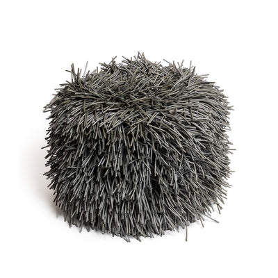 COVO Porcupine Pouf by Rosanna Contadini. A dense, spherical cluster of gray synthetic fibers radiates outward.