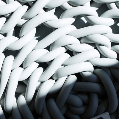 COVO Rebels 1 Pouf by Rosanna Contadini. White and dark twisted cylindrical forms create a dynamic three-dimensional pattern.