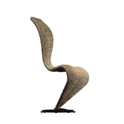 Cappellini S Chair by Tom Dixon. A woven rope sculpture with curved forms in tan and brown tones stands on a black base.