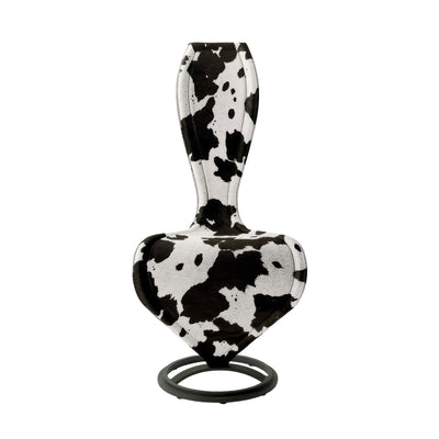 Cappellini S Chair by Tom Dixon. A black and white cow-print headphone with cushioned ear cups and a stabilizing base stand.