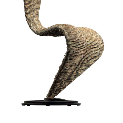 Cappellini S Chair by Tom Dixon. A woven rope sculpture in tan and brown tones curves gracefully on a black base.