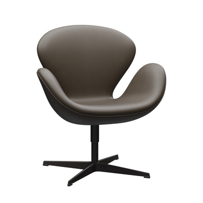 Fritz Hansen Swan™ Chair by Arne Jacobsen. A gray upholstered chair with curved armrests and a black pedestal base.