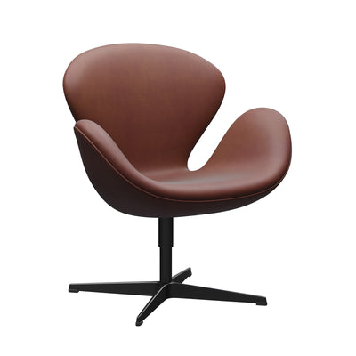 Fritz Hansen Swan™ Chair by Arne Jacobsen. A brown leather chair with curved armrests sits on a black pedestal base.