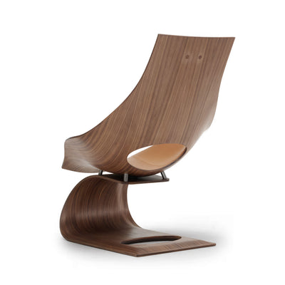 Carl Hansen & Søn TA001P Dream Chair by Tadao Ando. A curved wooden chair with a tan leather seat in a modern design.