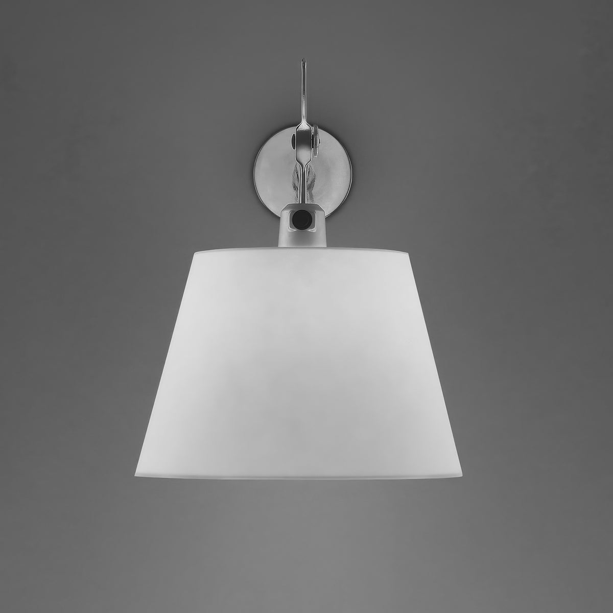 Artemide Tolomeo Diffusore Wall by Michele De Lucchi. Chrome fixture with white tapered shade against gray wall.