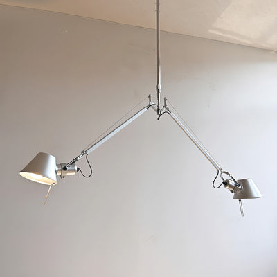 Artemide Tolomeo Due Bracci Suspension by Michele De Lucchi. Two silver metal lamps hang from a brushed steel frame.