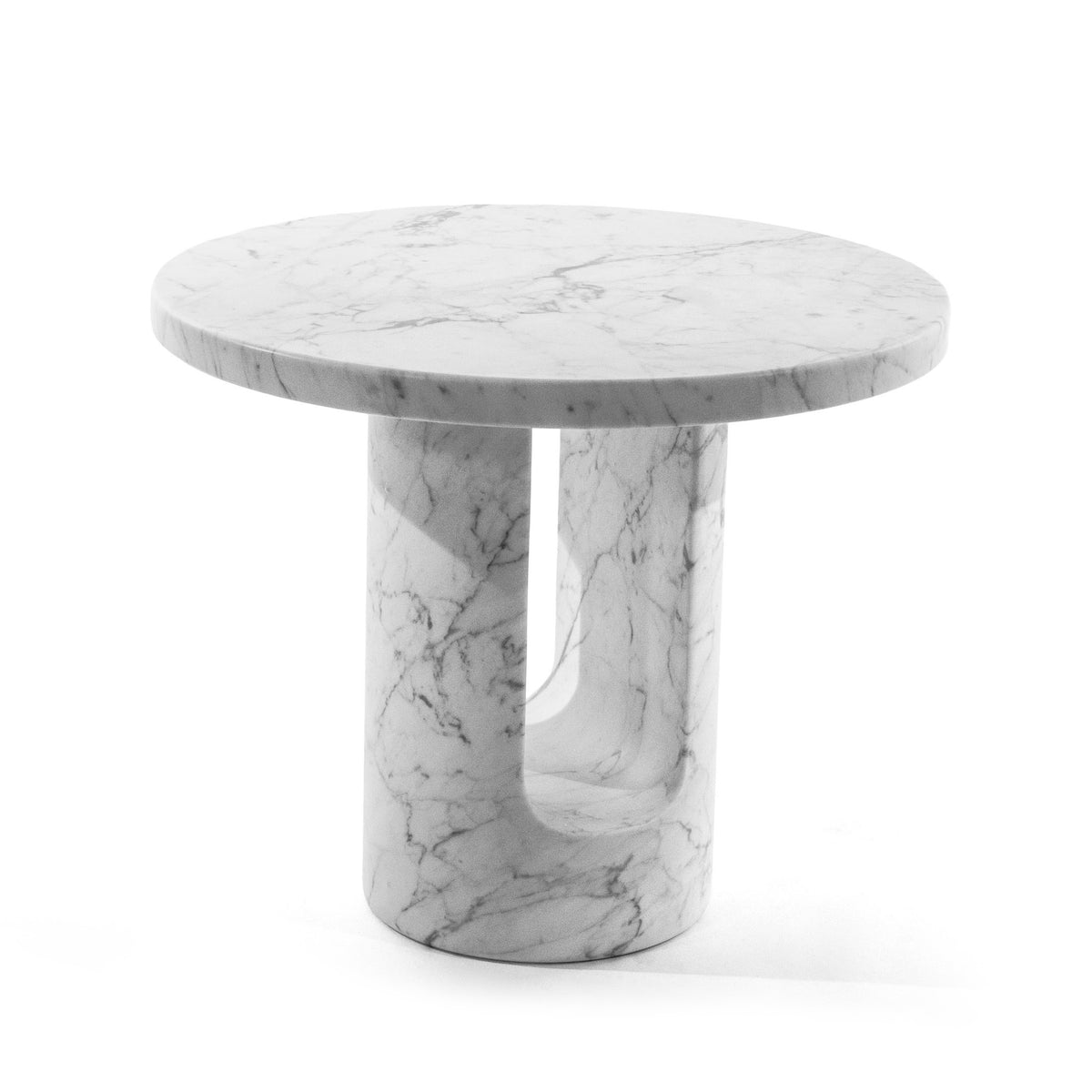 COVO U-TURN Table by Mikko Laakkonen. A round white marble table with veining sits on a cylindrical pedestal base.