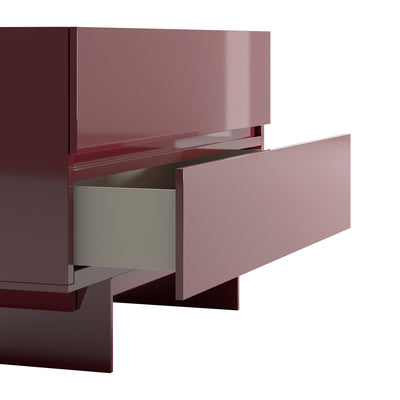 Cappellini Uni Notte by Piero Lissoni. A burgundy cabinet with a partially open drawer revealing a pale interior compartment.