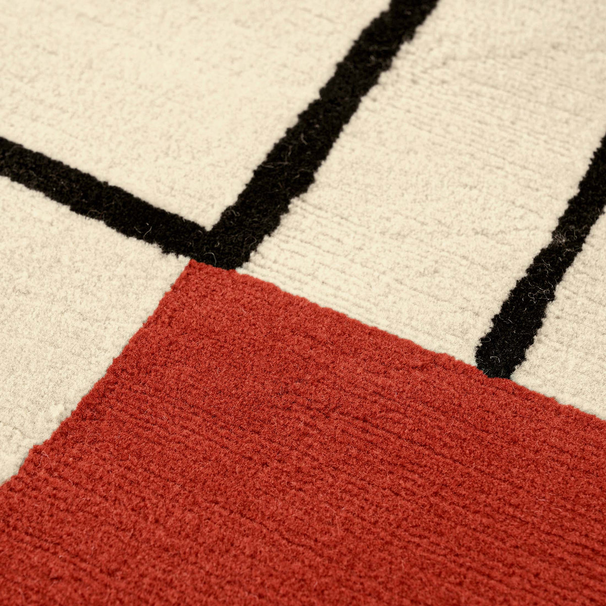 ClassiCon Wendingen Rug by Eileen Gray. A geometric textile features cream, black, and red colors in a modern design.