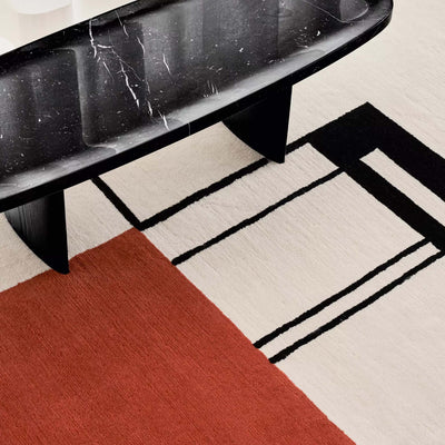 ClassiCon Wendingen Rug by Eileen Gray. Black marble table sits on geometric rug with red, cream, and black.