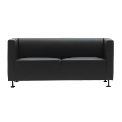 Cappellini Gambetta by Jasper Morrison. A sleek black leather sofa with metal legs sits against a white background.