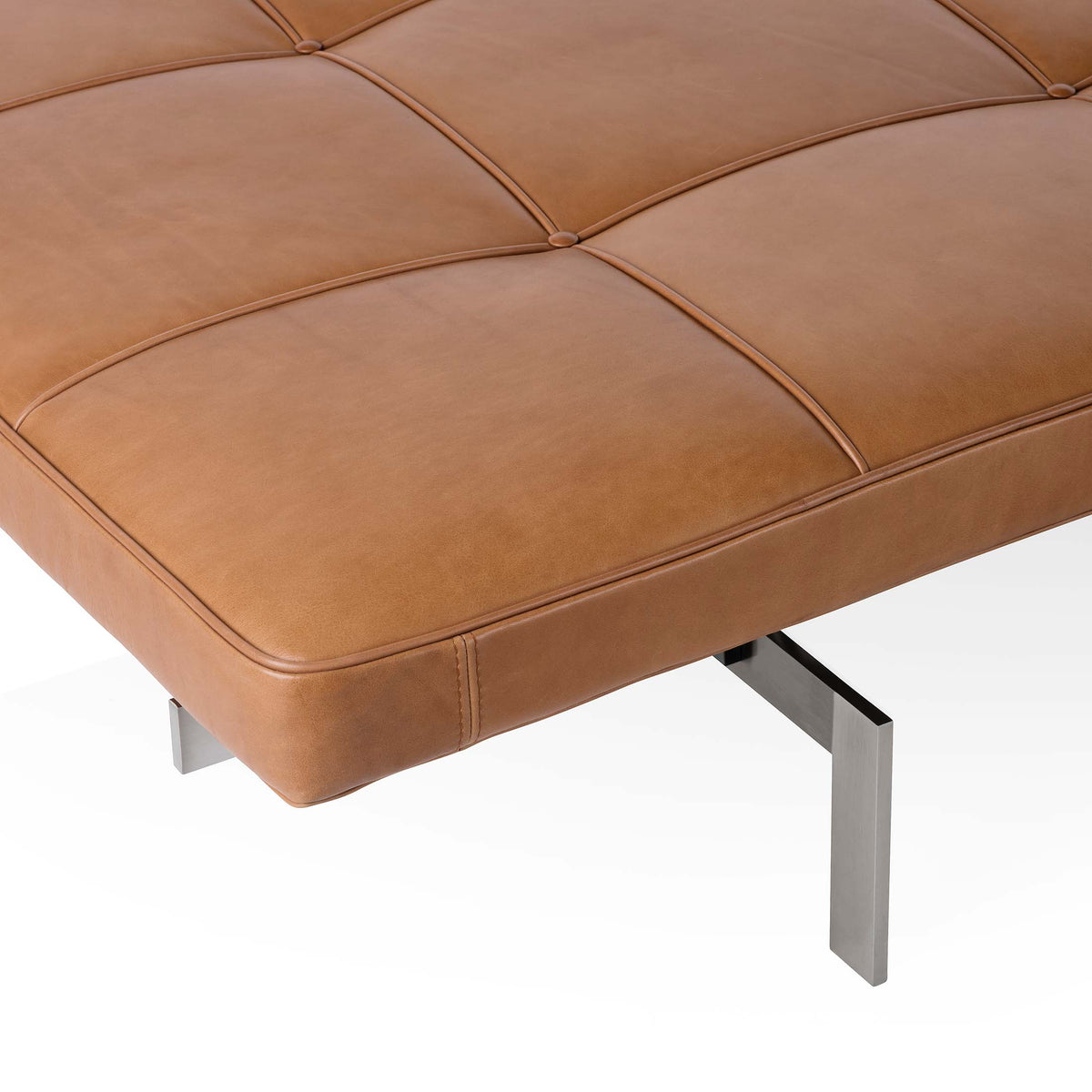 Fritz Hansen PK80™ Daybed by Poul Kjaerholm. Tan leather cushions with metal legs create a modern, minimalist seating piece.