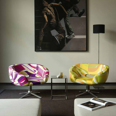 Cappellini Rive Droite by Patrick Norguet. Two vibrant patterned chairs sit facing each other in a modern gallery space.