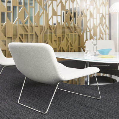 Cappellini Spring by Erwan & Ronan Bouroullec. White upholstered chair with chrome legs in modern office setting.